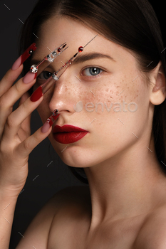 Portrait of a beautiful woman with classic make up in glamorous style, creative long nails. 