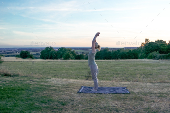 Senior woman practicing yoga outdoors. - Stock Photo - Images