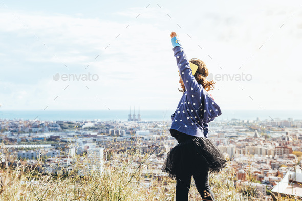 hero girl posing powerful with her fist in the air