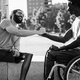 Multiethnic friends with disability greeting each other at park city  - PhotoDune Item for Sale