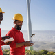 Multiracial engineer men working on windmill farm with digital tablet and drone - PhotoDune Item for Sale