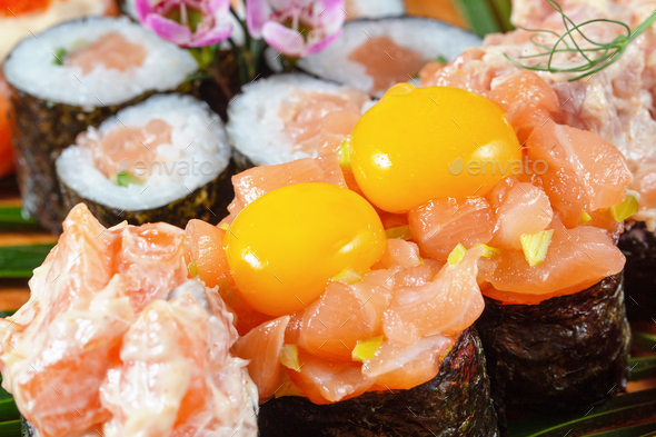 Sushi and rolls with red fish and raw quail eggs - Stock Photo - Images