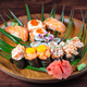 Sushi and rolls with raw quail eggs on wooden plate with green leaves - PhotoDune Item for Sale