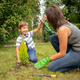 Mom and son planting plant together in garden - PhotoDune Item for Sale