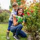 Mom and son taking care of plants in family garden - PhotoDune Item for Sale