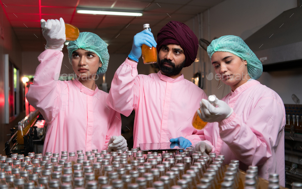 Product quality control staff at the fruit juice production line