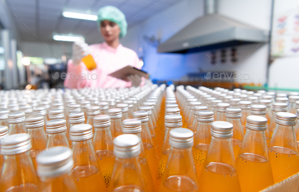 Product quality control staff at the fruit juice production line