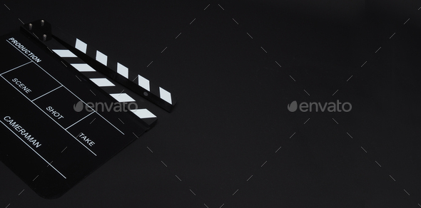 Clapperboard or clap board or movie slate on black background.
