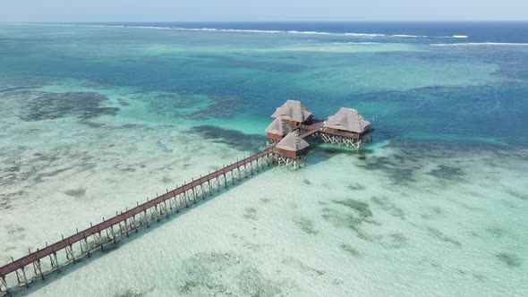 Aerial View of a House on Stilts in the Ocean on the Coast of Zanzibar Tanzania Slow Motion alt