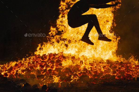 Summer solstice celebration jumping into the fire. Burning flames - Stock Photo - Images