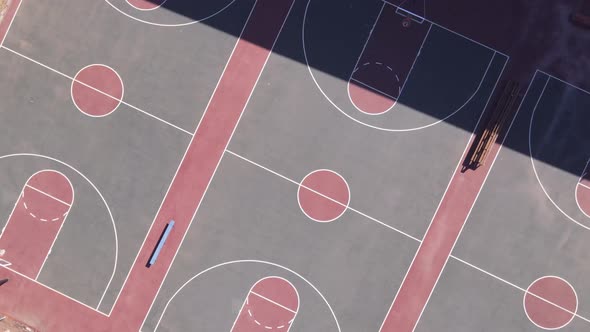Drone Panning Away From Basketball Court While Rotating