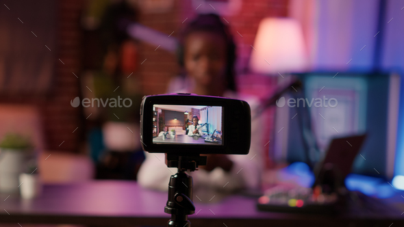 Selective focus on digital video camera screen recording african american woman streaming live