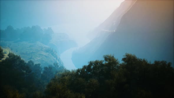 Sunrise in Mountains in a Foggy Morning alt