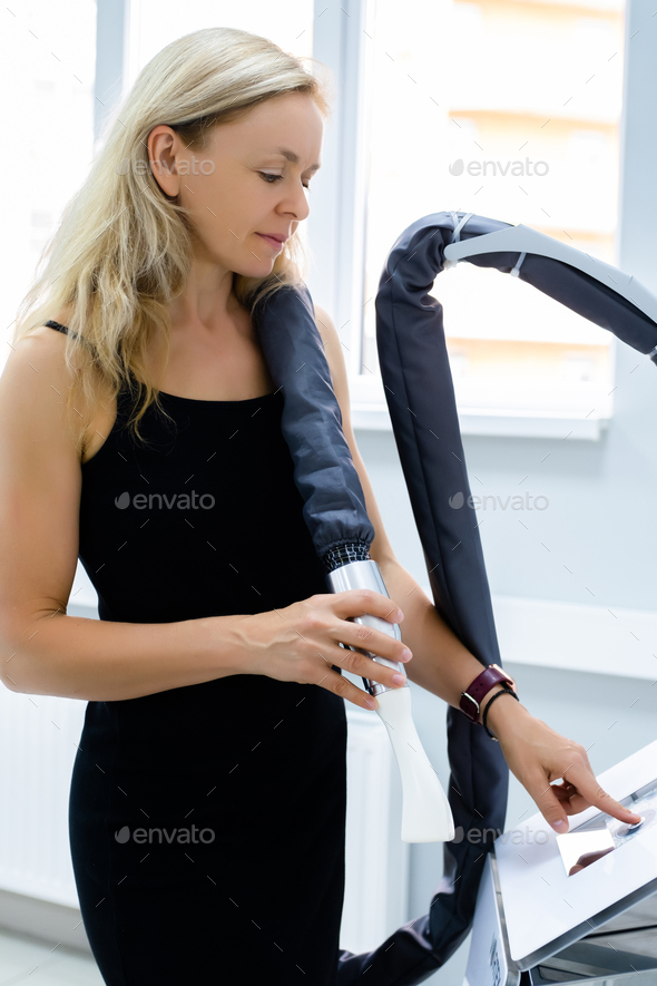 woman holds manipulator of apparatus anticellulite LPG massage. cosmetologist prepare for LPG
