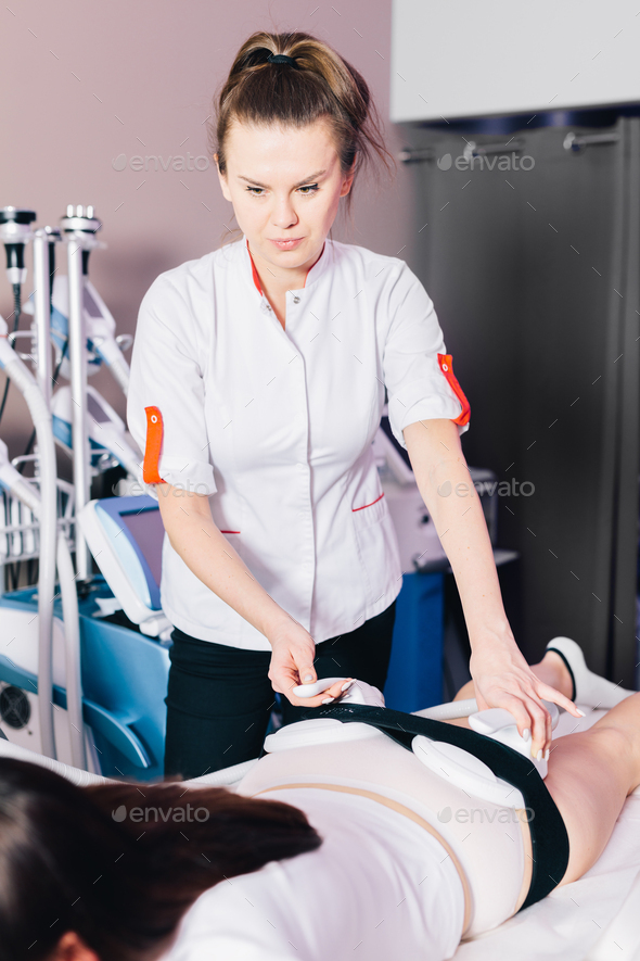 Woman getting ems treatment on buttocks to burn fat, build muscles and