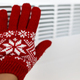 A woman warming her hand with a warm electric heater, saving energy, heating season concept - PhotoDune Item for Sale