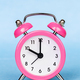 Alarm clock on a blue background, daylight savings time concept - PhotoDune Item for Sale