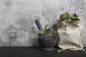 Food Background with Spices with Copy Space. Dried Bay Leaf in a Mortar on a Kitchen Countertop