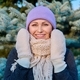 Mature woman in hat scarf mittens looking at camera in winter - PhotoDune Item for Sale
