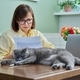 Business woman working from home, using laptop, along with pet cat - PhotoDune Item for Sale