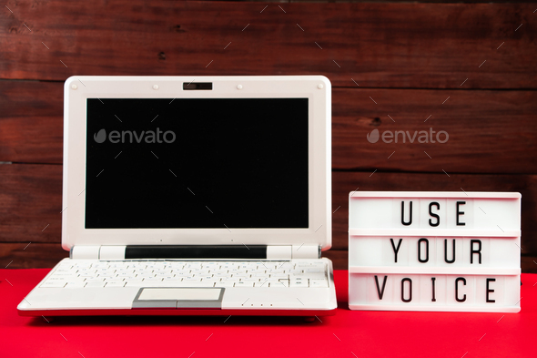 Online voting. Laptop and notepad on red background. Election concept, place for text.