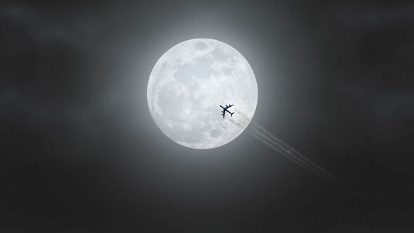 plane passing over full moonlight night loop