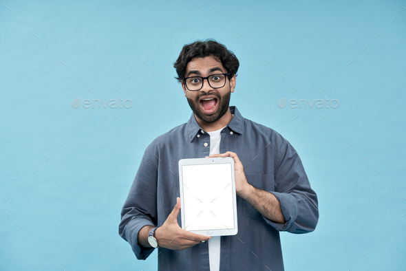 Excited arab student showing digital tablet mockup screen presenting online ad.