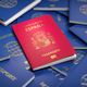 Passport of Spain on the pile of passports of other countries. - PhotoDune Item for Sale