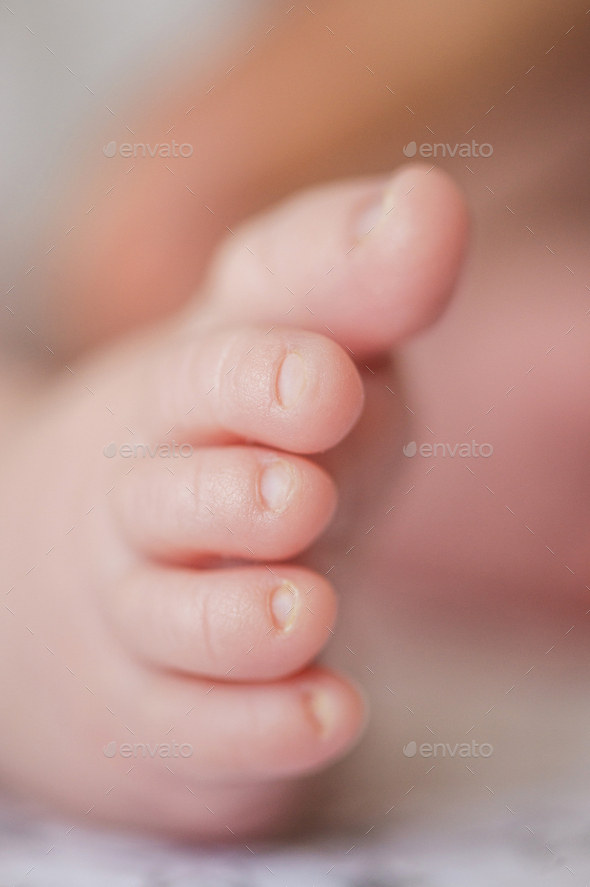 A tiny baby foot. Healthy and clean skin of a small child's leg. - Stock Photo - Images