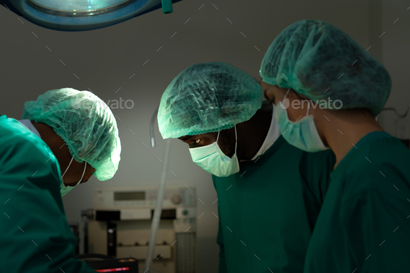 Professor of medicine in cardiology and a team of doctors in the operating room
