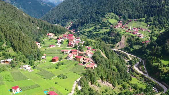 aerial drone circling a village located on the mountain cliff of Uzungol Trabzon on a sunny summer d alt