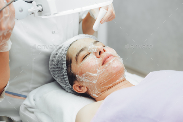 Cosmetic facial cleansing procedure for a young woman using a spoon uno.  - Stock Photo - Images