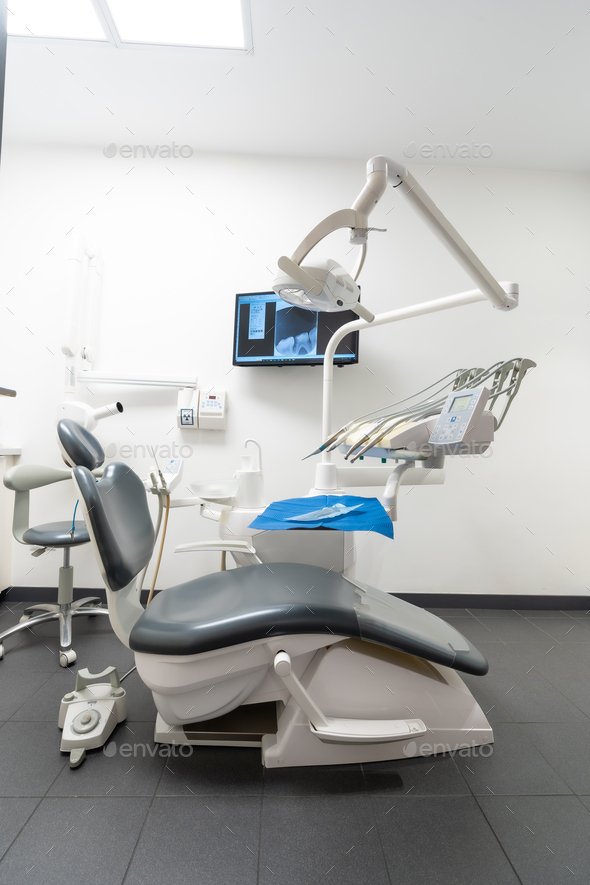 Modern dental practice. Dental chair, medical light, dental clinic without people. vertical photo