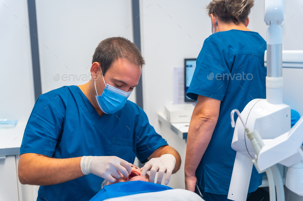 Dental clinic, dentist doctor and assistant examining the teeth of an elderly woman lying on table