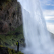waterfall person iceland looking Seljalandsfoss - PhotoDune Item for Sale