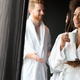 Beautiful black woman relaxing at luxury hotel spa wearing bathrobe and drinking coffee - PhotoDune Item for Sale