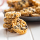 Wholegrain oat cookies. Cookies with oatmeal and raisins on white table. - PhotoDune Item for Sale