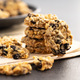 Wholegrain oat cookies. Cookies with oatmeal and raisins on newspapers. - PhotoDune Item for Sale