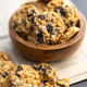 Wholegrain oat cookies. Cookies with oatmeal and raisins on newspapers. - PhotoDune Item for Sale