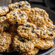 Wholegrain oat cookies. Cookies with oatmeal and raisins on wooden table. - PhotoDune Item for Sale