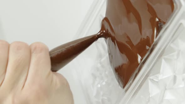 Vertical Shot Closeup Pouring Dark Chocolate Into Bar Diamond Shaped Mold Slow Motion