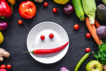 Flat lay, vegetables on a wooden background and an plate with paper.