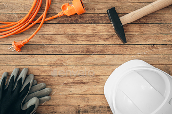 Flat lay composition with different construction tools on wooden background.