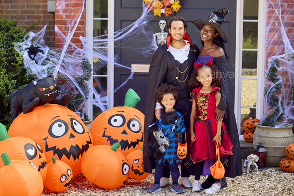 Portrait Of Family Dressed Up For Halloween Outside House Ready For ...