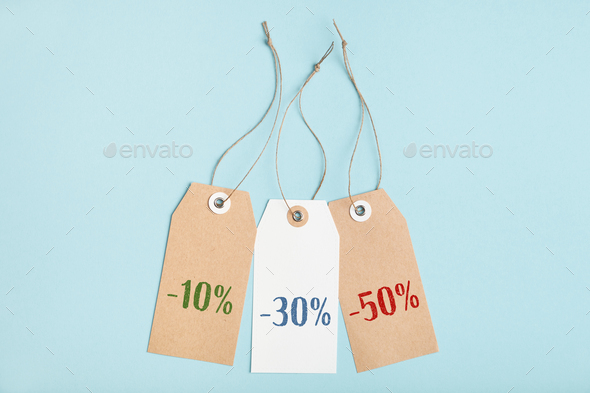 Set of tags with different percent discounts on a blue background. Seasonal sale in stores - Stock Photo - Images