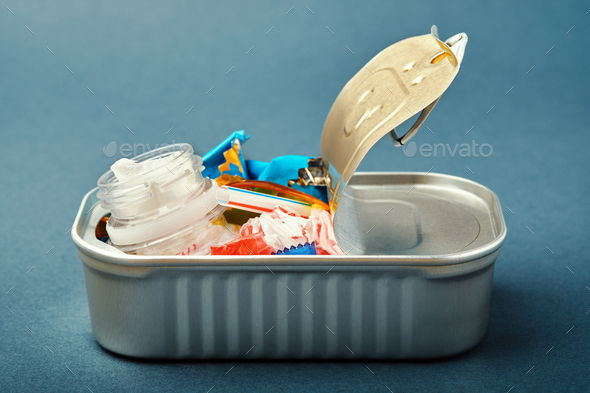 Open tin can. Plastic waste instead of fish inside. Ocean plastic pollution concept