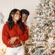 Portrait of happy black couple decorating Christmas tree - PhotoDune Item for Sale