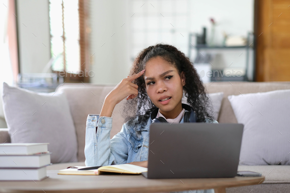 Exhausted female student feeling headache from problems with university course work connected
