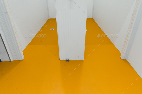 New polished concrete floor covered with a layer of yellow epoxy resin