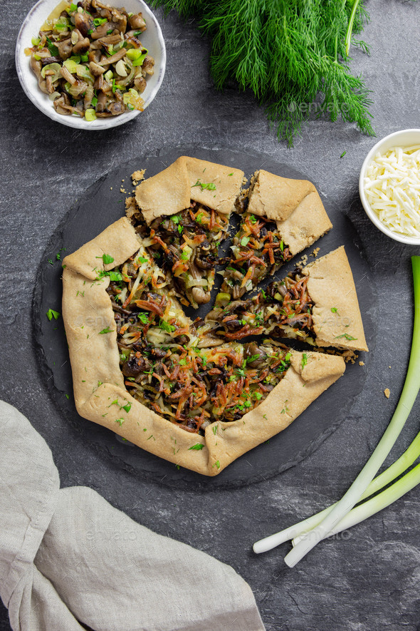 Open pie, galette with wald mushrooms, fried green onions, fresh herbs and cheese filling. Top